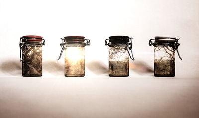 Abstract composite of glass jars and a landscape